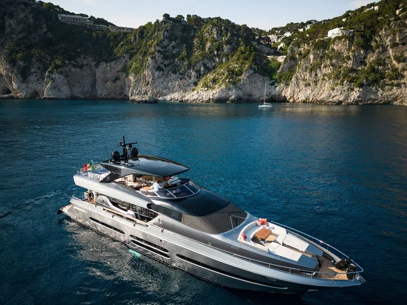 Slide: The Image of Posillipo Technema 90 yacht cruising in scenic coastal waters, 2024 model. - 2