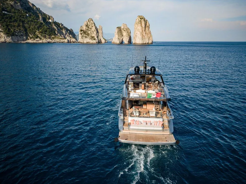 Slide: The Image of Luxury Posillipo Technema 90 yacht cruising near rocky coastline, 2024 model. - 4