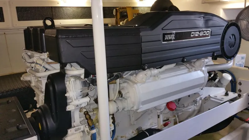 Slide: The Image of Interior of a 2006 Silverton 50 Convertible yacht with seating and control area. - 12