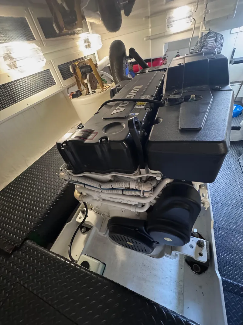 Slide: The Image of Engine room of a 2006 Silverton 50 Convertible yacht, featuring dual engines and clean layout. - 15