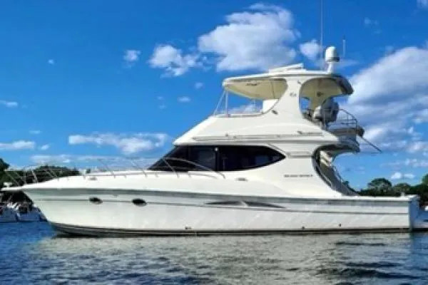 Slide: The Image of 2006 Silverton 50 Convertible yacht on water under blue sky. - 2