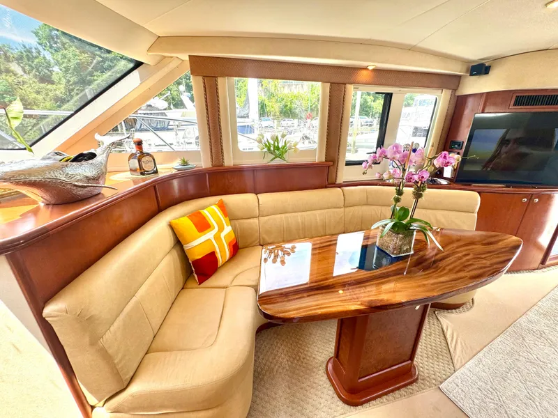 Slide: The Image of Luxurious interior of a 2006 Silverton 50 Convertible yacht with elegant wood finishes and plush seating. - 27