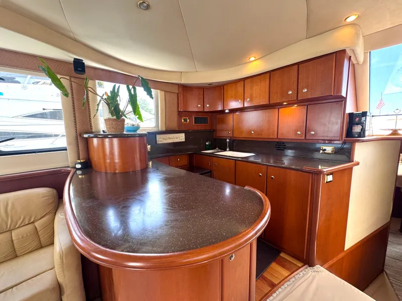 Slide: The Image of Interior of 2006 Silverton 50 Convertible yacht with wooden cabinetry and modern design. - 29