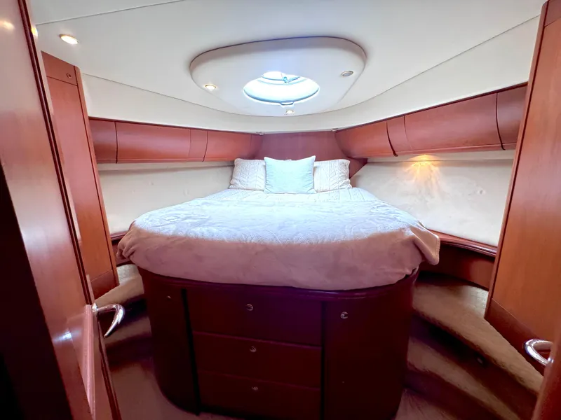 Slide: The Image of Luxurious bedroom interior of 2006 Silverton 50 Convertible yacht with cozy bed and wooden finish. - 33