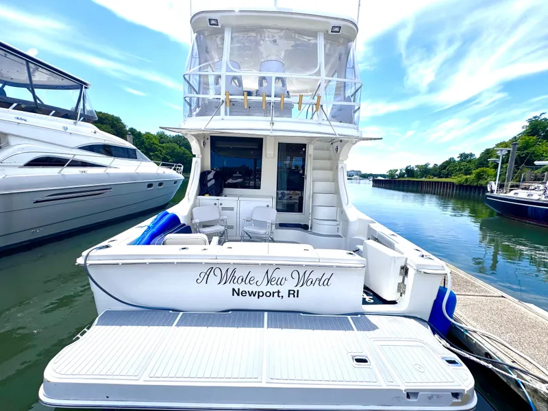 Slide: The Image of 2006 Silverton 50 Convertible yacht docked under a clear blue sky. - 4