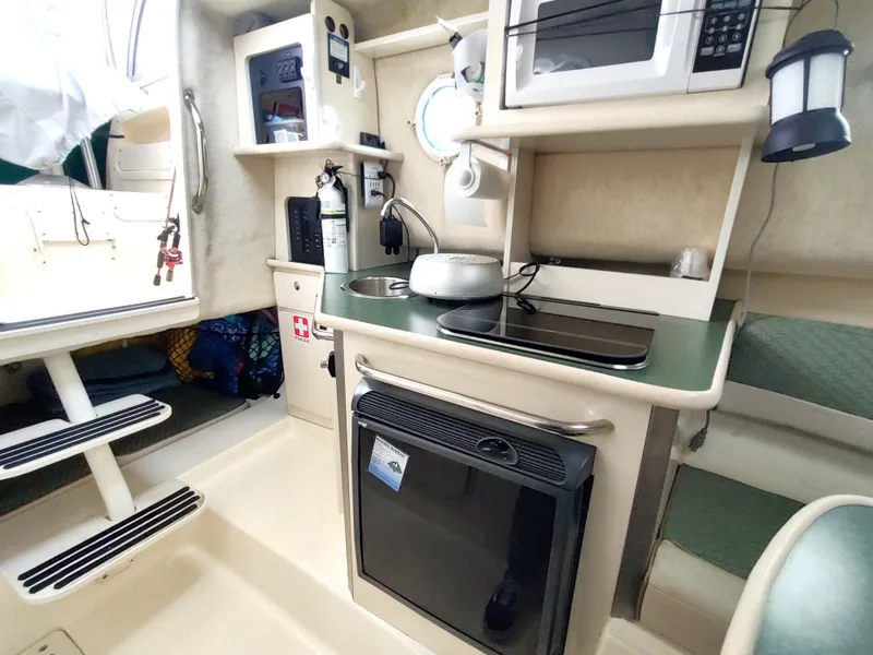 Slide: The Image of 2003 Trophy 2902 Walkaround boat interior with kitchenette and appliances. - 10