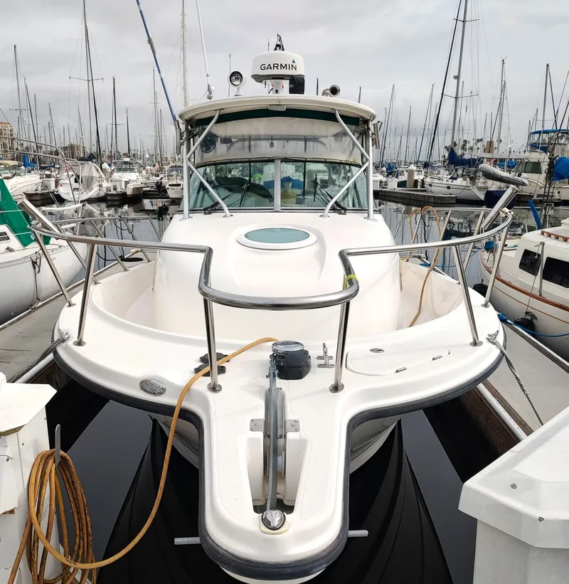 Slide: The Image of 2003 Trophy 2902 Walkaround boat docked in a marina. - 2