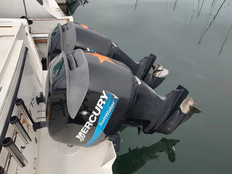 Slide: The Image of Twin Mercury Saltwater outboard engines on a 2003 Trophy 2902 Walkaround boat. - 4