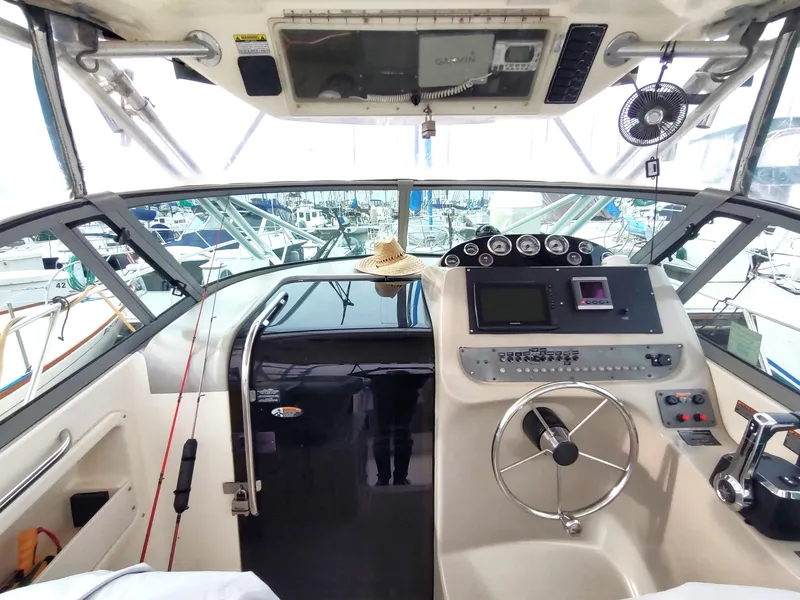 Slide: The Image of 2003 Trophy 2902 Walkaround boat cockpit with steering wheel and control panel. - 6