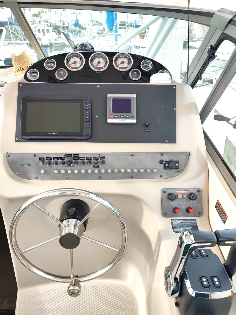 Slide: The Image of 2003 Trophy 2902 Walkaround boat helm with navigation instruments and controls. - 7
