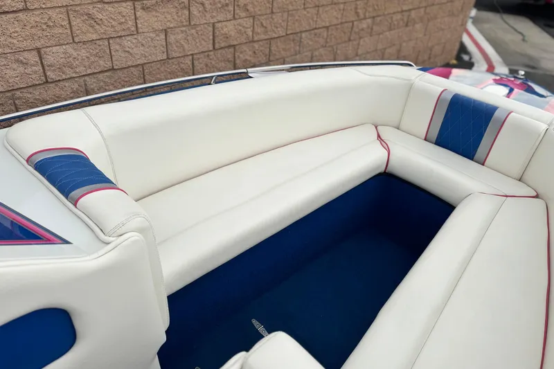 Slide: The Image of Interior seating of a 1994 Howard 22 Bowrider boat with white and blue upholstery. - 11