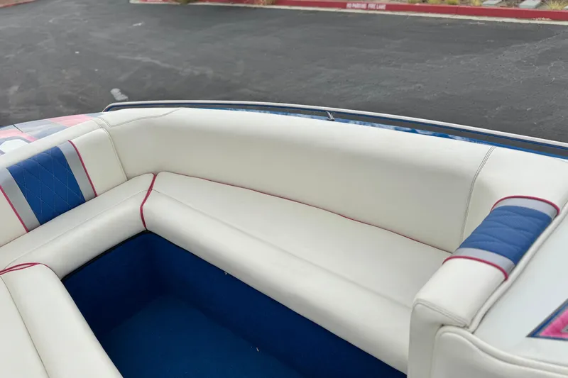 Slide: The Image of 1994 Howard 22 Bowrider boat interior with white and blue seating. - 12
