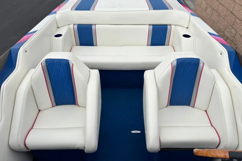 Slide: The Image of 1994 Howard 22 Bowrider boat interior with white, blue, and pink seating. - 15