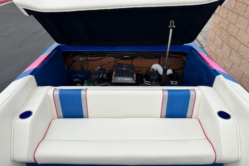 Slide: The Image of 1994 Howard 22 Bowrider boat engine compartment with open hatch and seating area. - 18