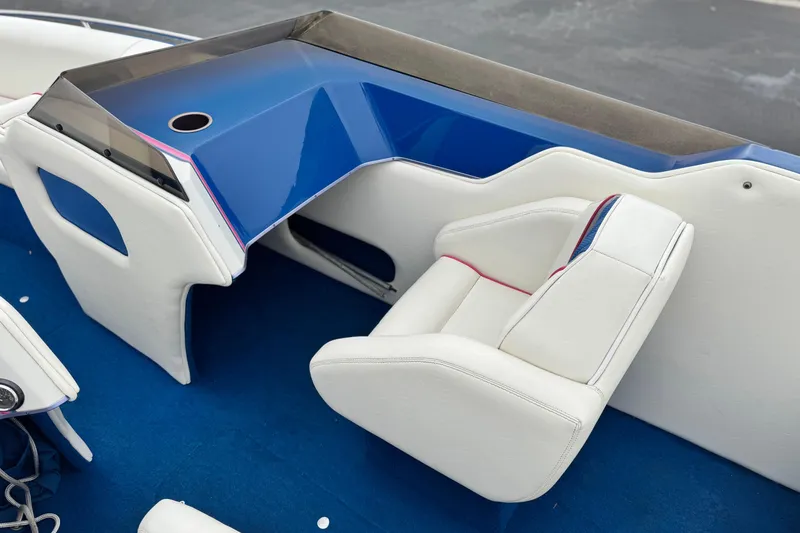 Slide: The Image of 1994 Howard 22 Bowrider interior with white seating and blue accents. - 20