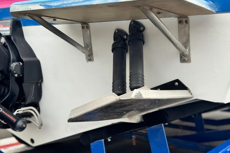 Slide: The Image of 1994 Howard 22 Bowrider boat stern with trim tabs and outboard motor detail. - 7