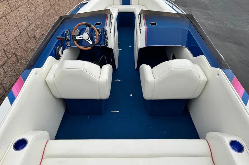 Slide: The Image of 1994 Howard 22 Bowrider boat interior with white seats and blue accents. - 8