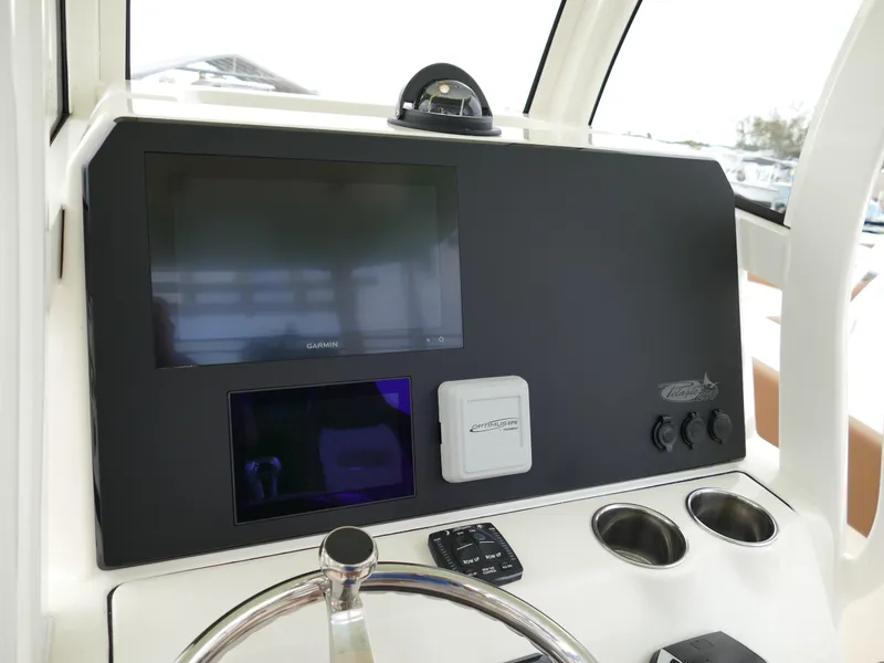 Slide: The Image of 2024 Pioneer 270 Pelagic boat dashboard with navigation screens and controls. - 12