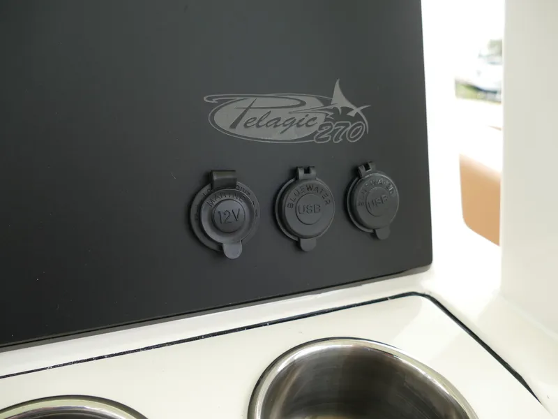 Slide: The Image of 2024 Pioneer 270 Pelagic boat console with 12V, USB, and AUX ports. - 15
