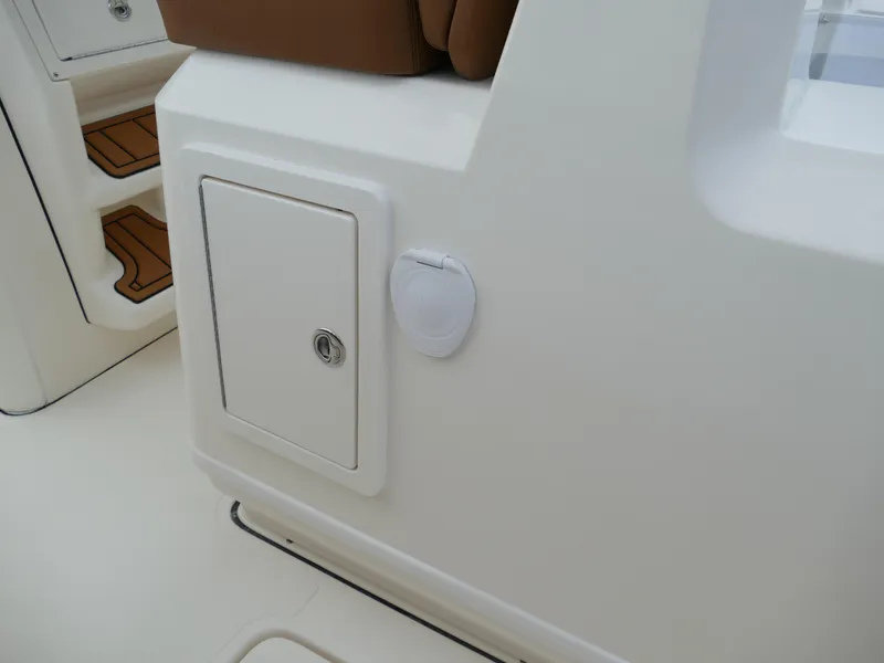 Slide: The Image of 2024 Pioneer 270 Pelagic boat interior with storage compartment and seating. - 35