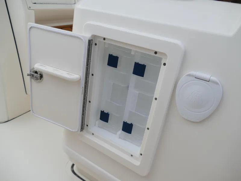 Slide: The Image of Open storage compartment on a 2024 Pioneer 270 Pelagic boat. - 36
