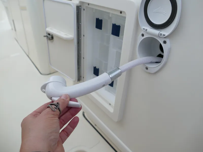 Slide: The Image of Hand holding hose on 2024 Pioneer 270 Pelagic boat. - 37