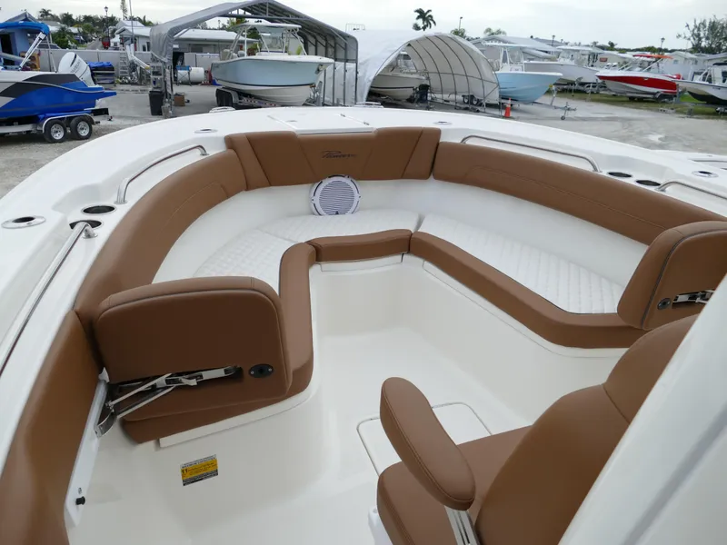 Slide: The Image of 2024 Pioneer 270 Pelagic boat interior with brown and white seating. - 40