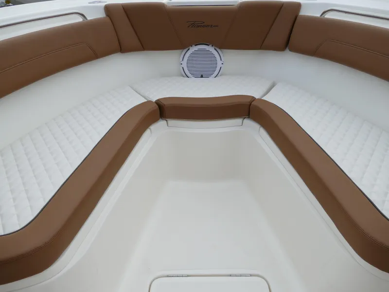 Slide: The Image of 2024 Pioneer 270 Pelagic boat interior with brown and white cushioned seating. - 41