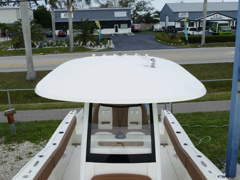 Slide: The Image of 2024 Pioneer 270 Pelagic boat with a white hardtop and tan seating. - 44
