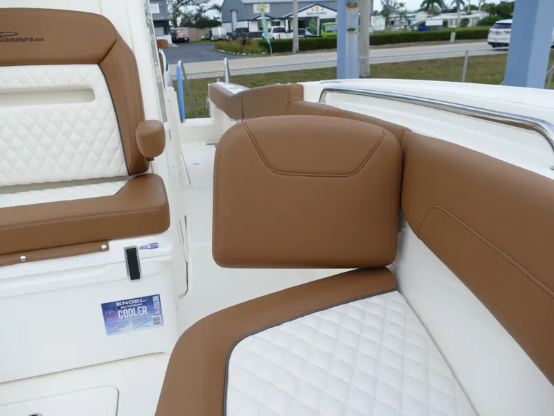 Slide: The Image of 2024 Pioneer 270 Pelagic boat interior with brown and white cushioned seating. - 47