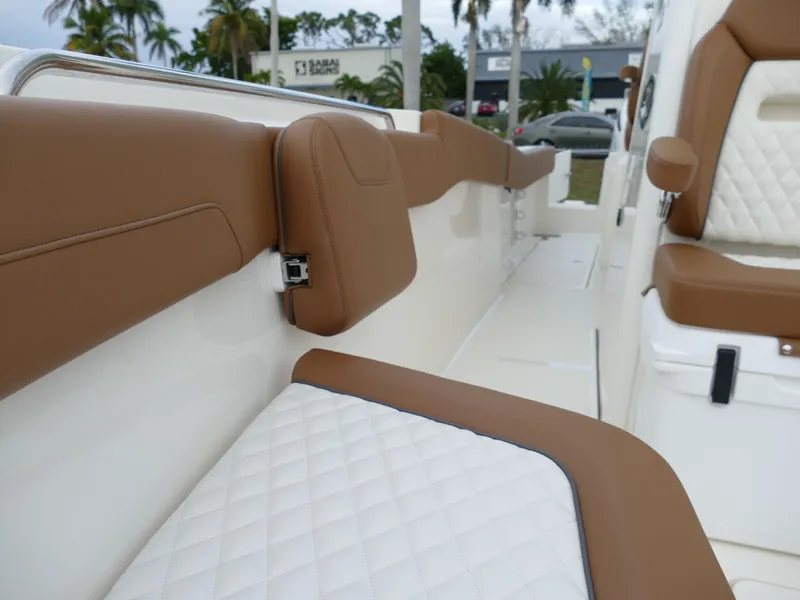 Slide: The Image of 2024 Pioneer 270 Pelagic boat interior with brown and white cushioned seating. - 48