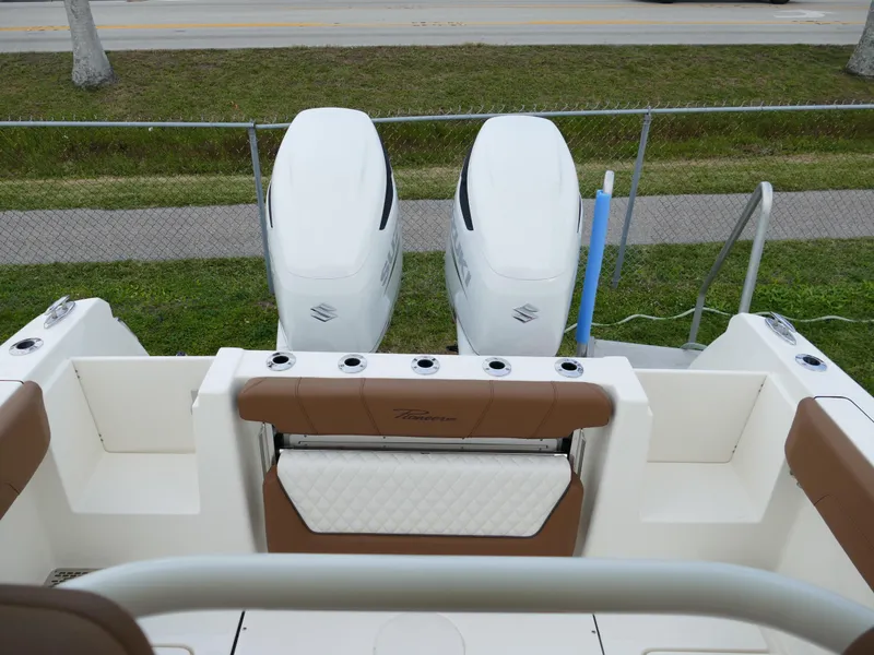 Slide: The Image of 2024 Pioneer 270 Pelagic boat with dual outboard engines, rear seating, and rod holders. - 49