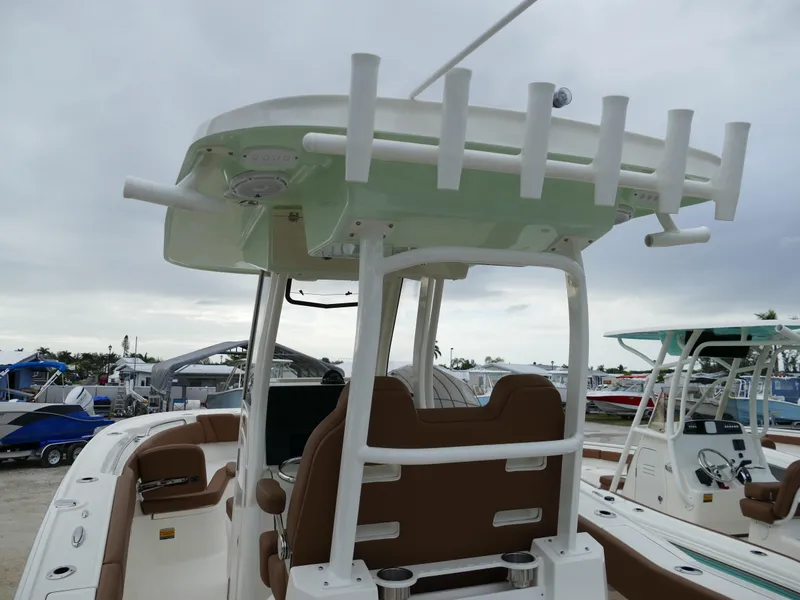 Slide: The Image of 2024 Pioneer 270 Pelagic boat with rod holders and brown seating. - 5