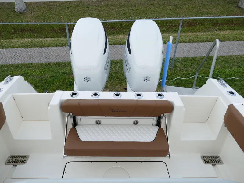 Slide: The Image of 2024 Pioneer 270 Pelagic boat with dual outboard engines and cushioned seating. - 50