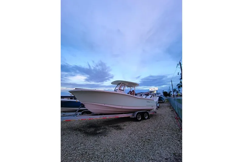 Slide: The Image of 2024 Pioneer 270 Pelagic boat on trailer at sunset, showcasing sleek design. - 78