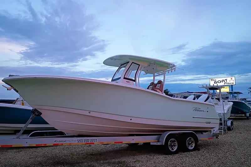 Slide: The Image of 2024 Pioneer 270 Pelagic boat on trailer at dealership, evening sky backdrop. - 79