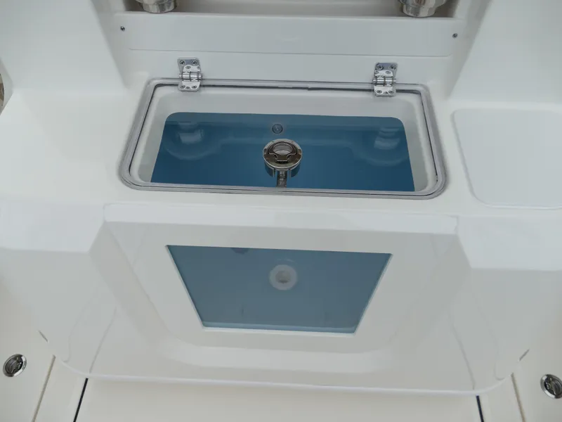 Slide: The Image of 2024 Pioneer 270 Pelagic livewell with clear lid and blue interior. - 9