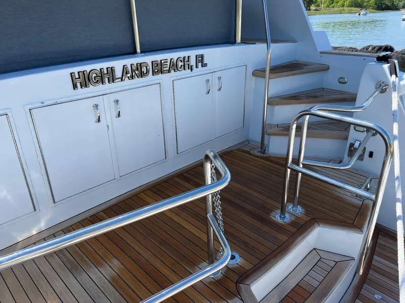Slide: The Image of 1999 Hatteras 74 Sport Deck Motor Yacht with teak deck and stainless steel railings. - 13