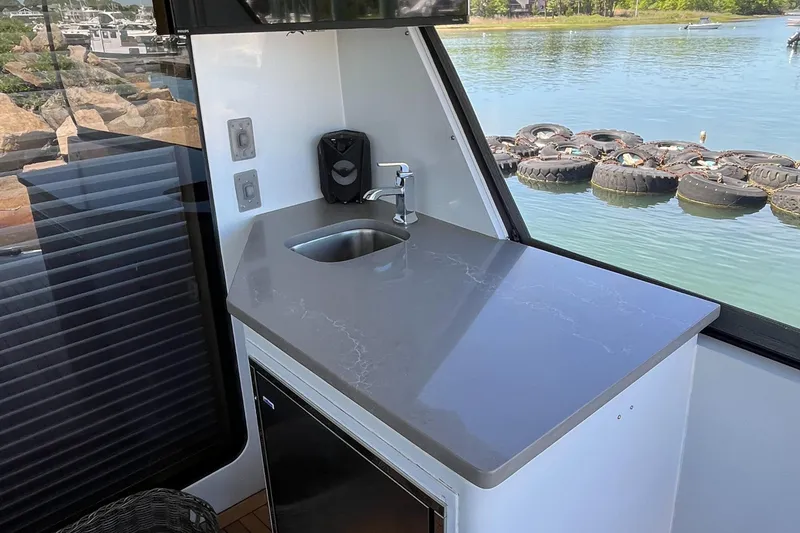 Slide: The Image of Kitchen area on 1999 Hatteras 74 Sport Deck Motor Yacht with sink and countertop. - 14