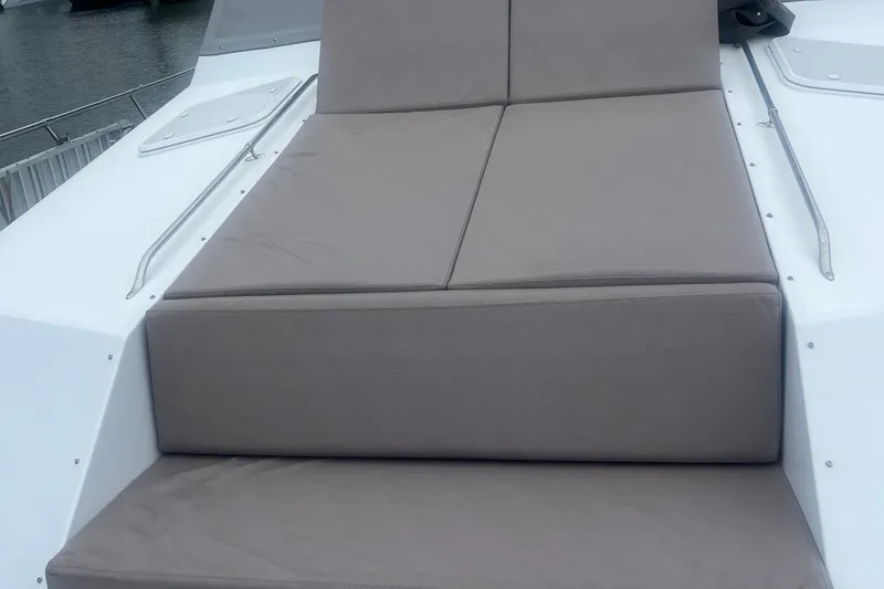 Slide: The Image of 1999 Hatteras 74 Sport Deck Motor Yacht with cushioned sunbathing area on deck. - 162