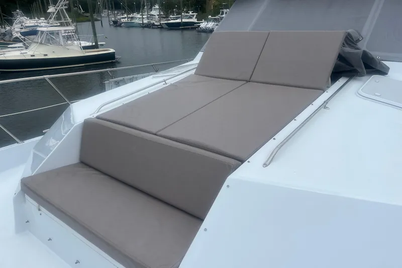 Slide: The Image of 1999 Hatteras 74 Sport Deck Motor Yacht with cushioned sunbathing area on deck. - 163
