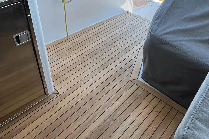 Slide: The Image of Teak deck of 1999 Hatteras 74 Sport Deck Motor Yacht, featuring stainless steel elements. - 18