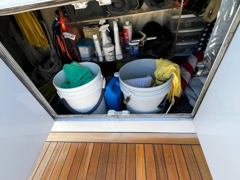 Slide: The Image of Storage compartment on a 1999 Hatteras 74 Sport Deck Motor Yacht with cleaning supplies. - 21