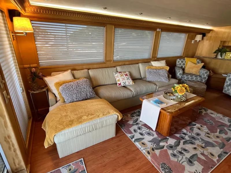 Slide: The Image of Luxurious interior of a 1999 Hatteras 74 Sport Deck Motor Yacht with cozy seating and decor. - 23