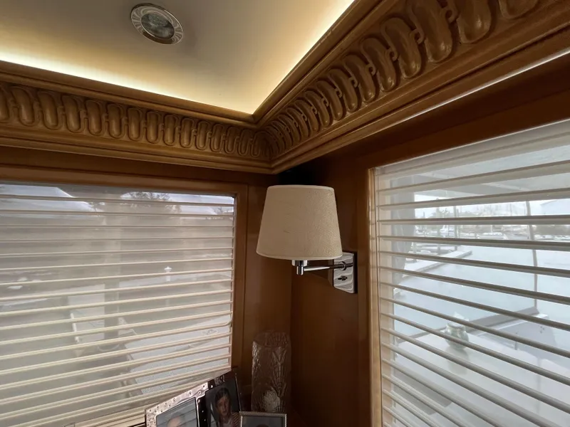 Slide: The Image of Interior of 1999 Hatteras 74 Sport Deck Motor Yacht with elegant wood trim and wall lamp. - 24