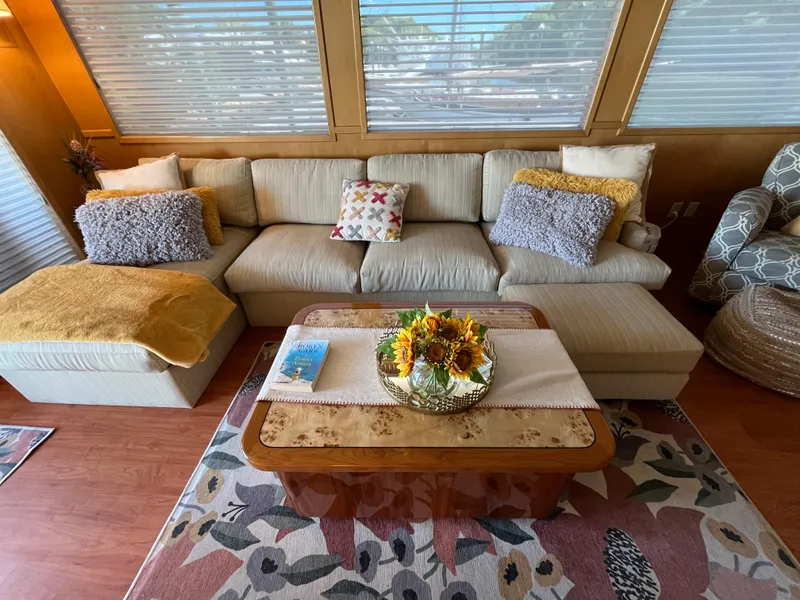 Slide: The Image of Cozy living area in 1999 Hatteras 74 Sport Deck Motor Yacht with plush seating and floral decor. - 25