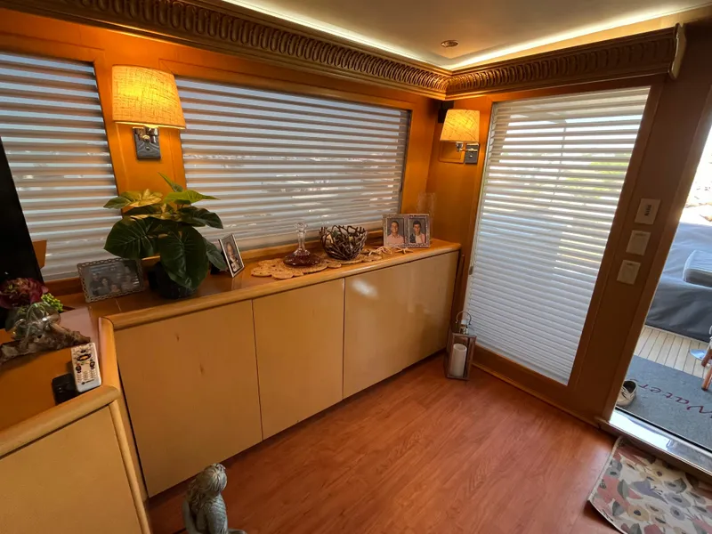 Slide: The Image of Interior of 1999 Hatteras 74 Sport Deck Motor Yacht with elegant decor and warm lighting. - 27