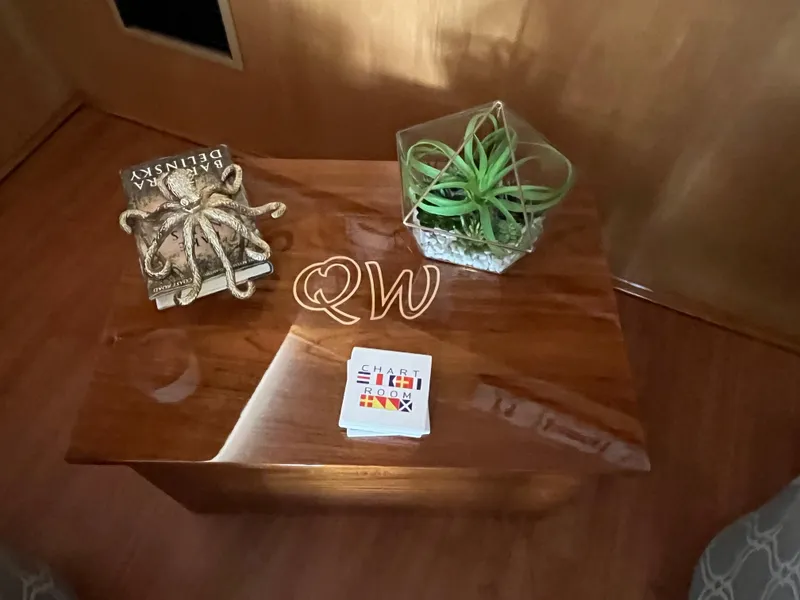 Slide: The Image of Wooden table with decor items on a 1999 Hatteras 74 Sport Deck Motor Yacht. - 29