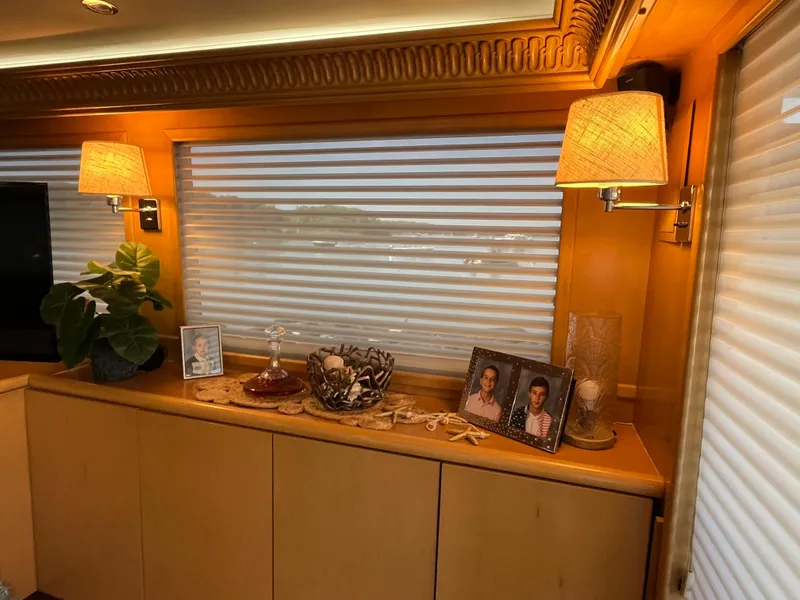 Slide: The Image of Interior of 1999 Hatteras 74 Sport Deck Motor Yacht with decor and framed photos. - 33
