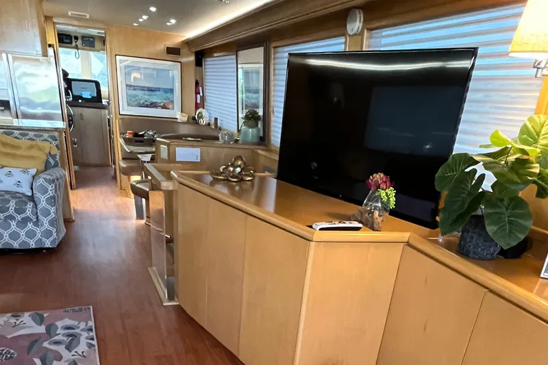 Slide: The Image of Luxurious interior of 1999 Hatteras 74 Sport Deck Motor Yacht with modern decor and large TV. - 34